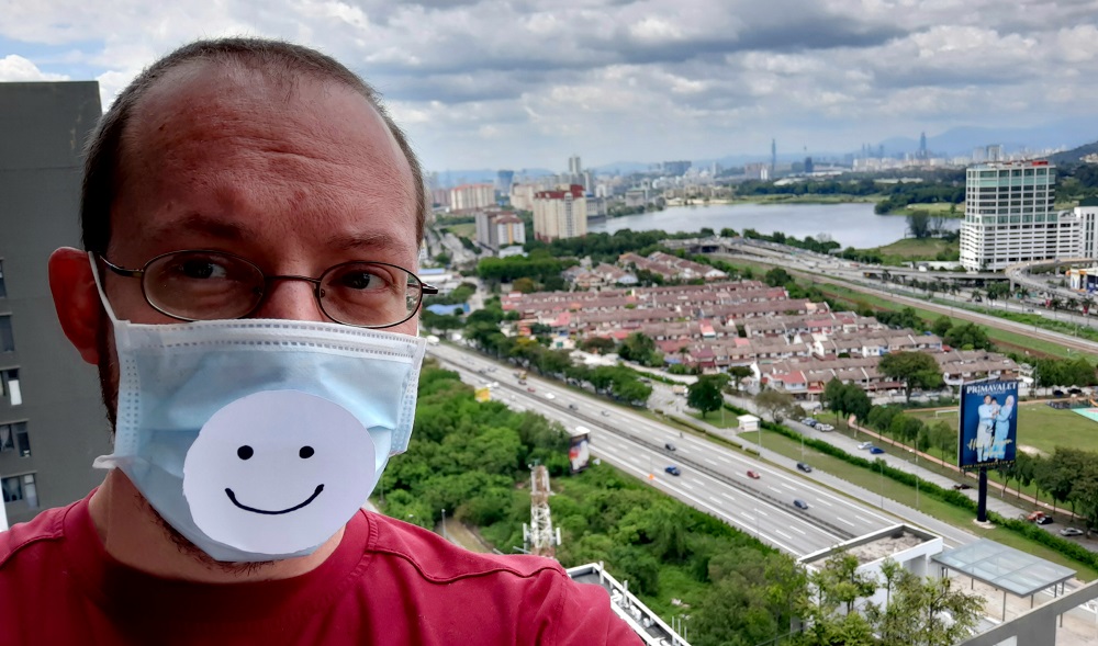 Author wearing face mask with smiley face