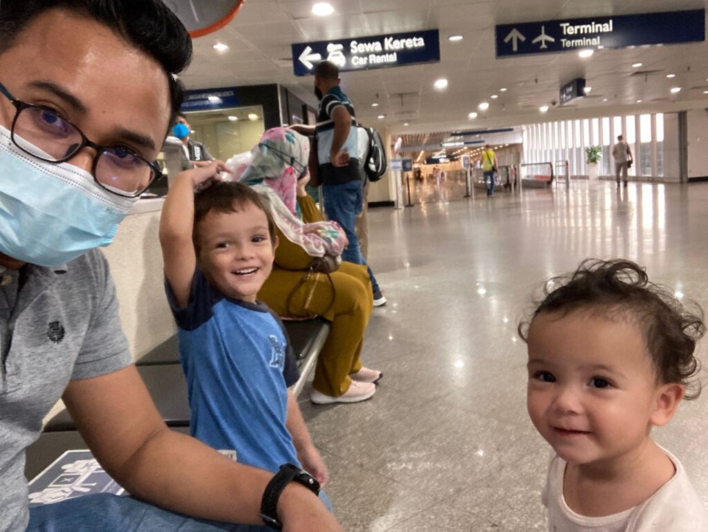 Kids smiling in airport terminal