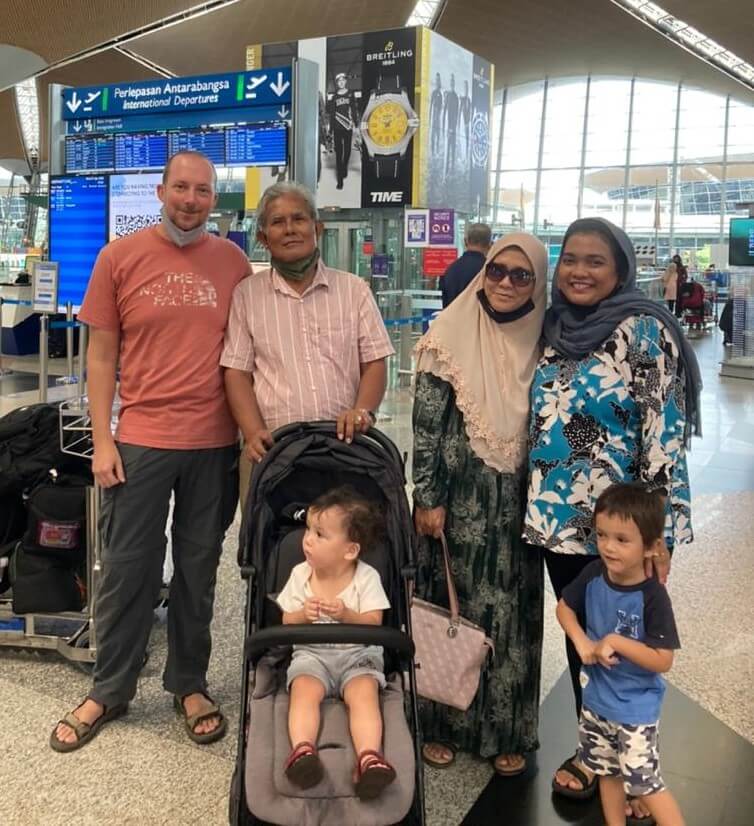 Family posing together at airport, sending off