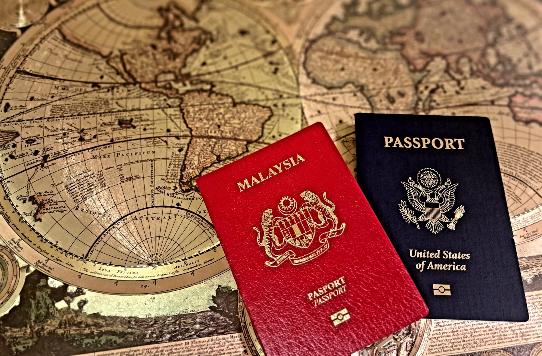 Two passports sitting on a world map