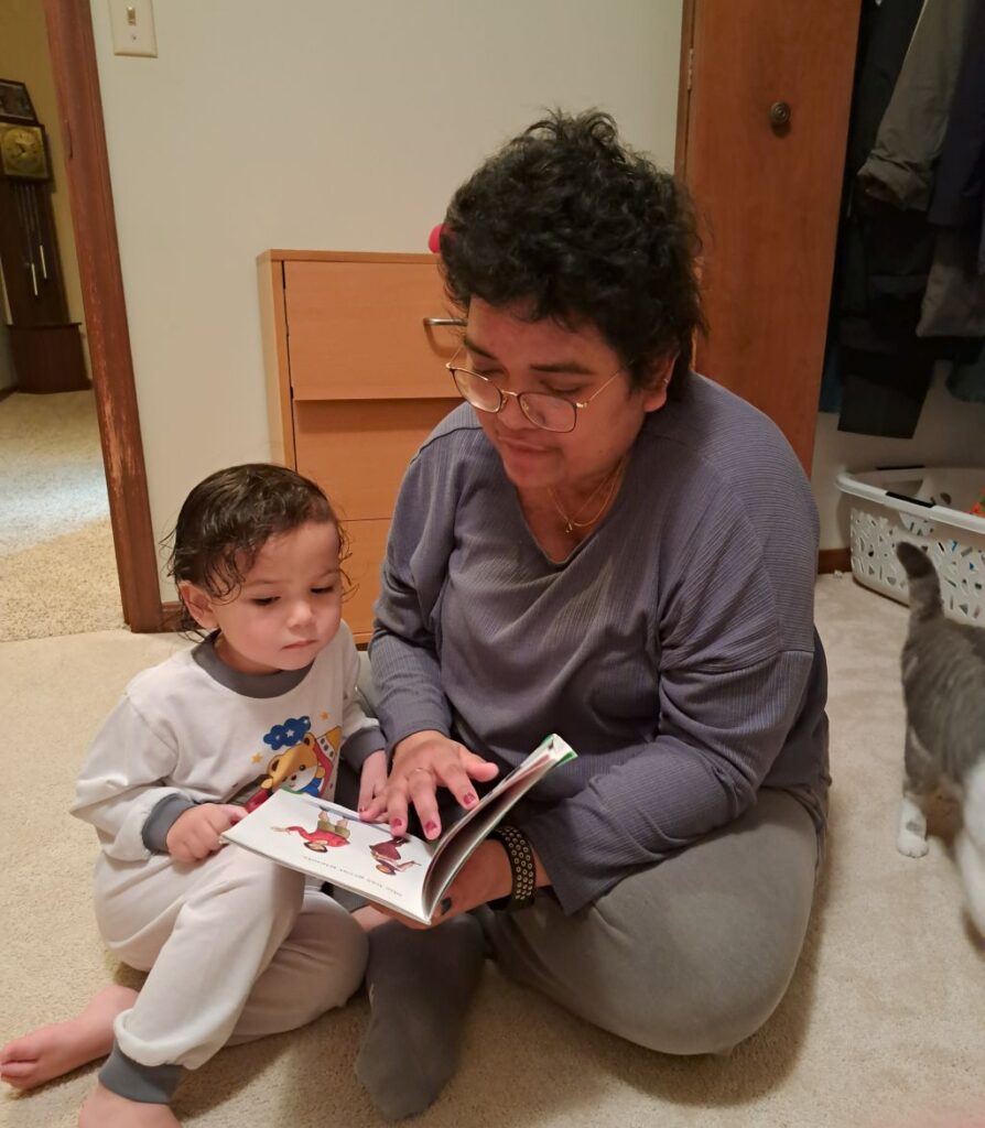 mom reading to leila who is wearing white pajamas